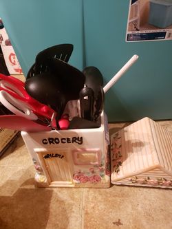 Cookie jar with utensils.