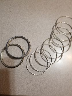 12 Silver colored bracelets