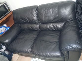 Black leather love couch