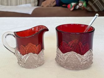 Ruby red flashed EAPG creamer and sugar bowl with clear cut glass base.