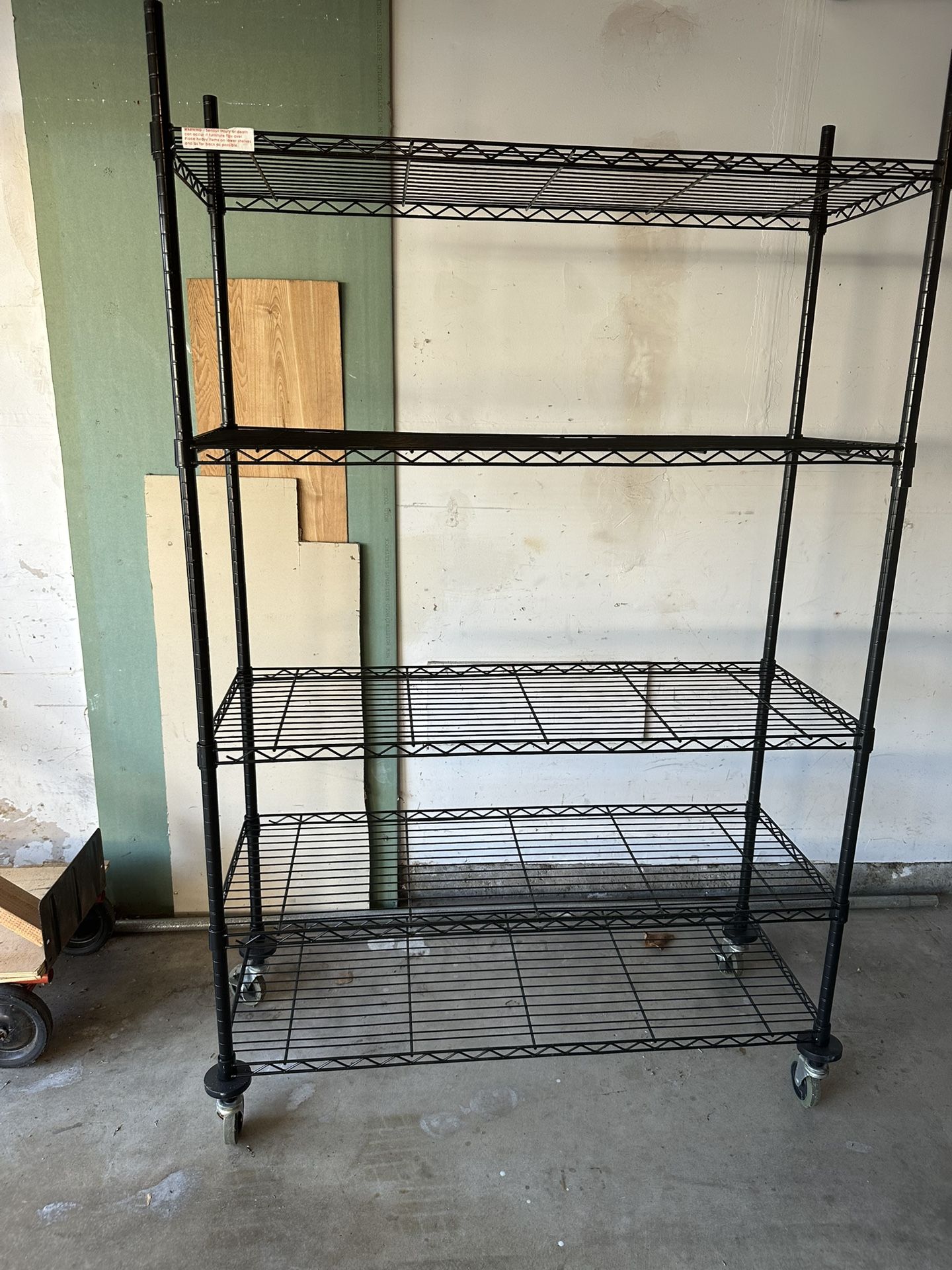 Metal garage shelving on wheels measures 71 inches high by 47 inches wide