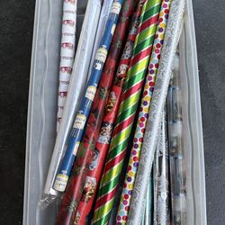 19 rolls of wrapping paper, some new. Container included.