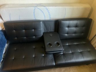 Black faux leather futon with cub holders