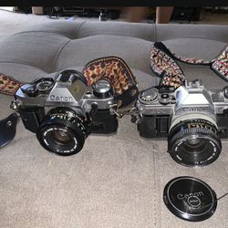 Vintage Canon AE-1 35mm SLR Camera With 50mm Lens & Canon AT-1 35mm SLR Camera With 50mm Lens