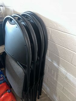 Gray padded folding chairs