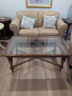 Like new solid wood coffee table with glass top.