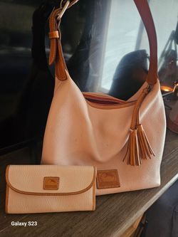 Dooney Burke purse and wallet.  Light pink. Great condition