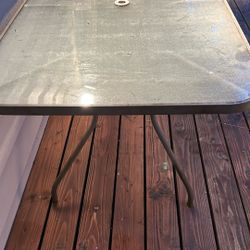 Glass Outdoor Table And Six Folding Chairs