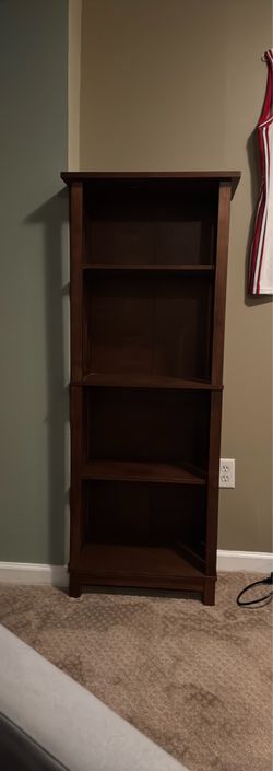 Tall dark wood shelving unit