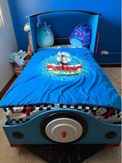 Train bed with mattress and box spring. Used under 10 times.