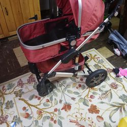 Red Baby Stroller And Baby Carrier
