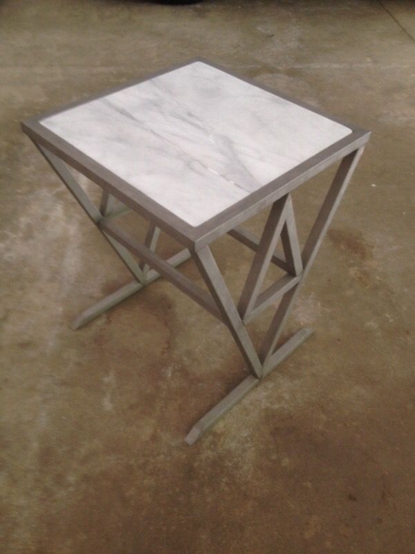 Brash stainless steel table with marble top