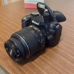 Nikon D3100 digital SLR camera equipped with a 18-55mm lens