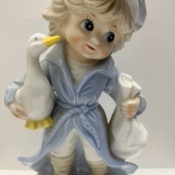 VINTAGE: "CHILD HOLDING GOOSE & BAG" 7  1/2" PORCELAIN FIGURINE