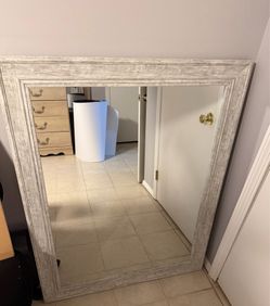 Mirror. large rectangular wall or floor- measuring 38 inches by 48 inches, featuring a distinct rustic or farmhouse style frame. The frame is crafted 