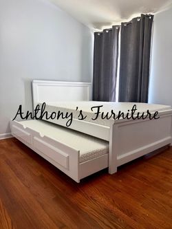White full bed with trundle and mattresses