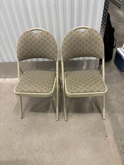 Two folding chairs with cloth padding in excellent condition like new.. $40 each