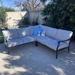 Outdoor sectional with cover and decorative pillows