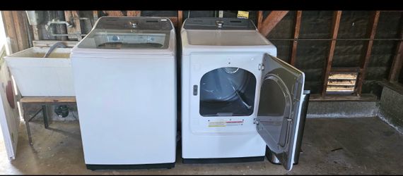 Samsung top-load electric washer and dryer set in white.