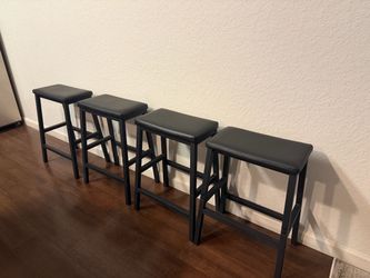 4 black barstools, padded seats