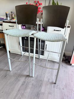 3 wooden and metal high chairs.