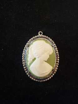 $8. Cameo inspired green and silver tone necklace pendant. 2.25 in long and 1.5 in wide.