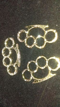 Gold plated brass knuckles. PENDANT ONLY NOT REAL BRASS KNUCKLES. Brand New. ONLY $30 each. Free chain included with each pendant purchased.