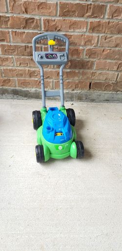 Play Day bubble mower features a vibrant green and blue design and is engineered to produce bubbles while mimicking the sounds of a real lawnmower.