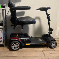 This is a Merits Roadster S4 4-wheeled mobility scooter.  It has a weight capacity of up to 300 lbs. 