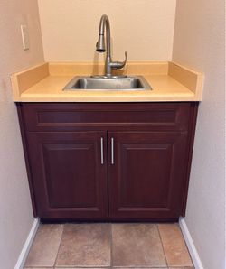 Cabinet for laundry room includes sink & faucet- uppers also available