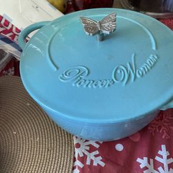 Dutch oven. Made by pioneer women. Color blue. Butterfly on top of pot for handle.