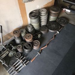 Huge lot of standard 1 inch weight plates and barbells