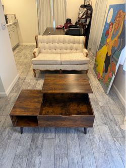 Modern Lift-Top Coffee Table with Hidden Storage  Beautiful modern coffee table in excellent condition. Features a lift-top design that raises to a co