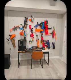 Nerf guns and backlit pegboard wall