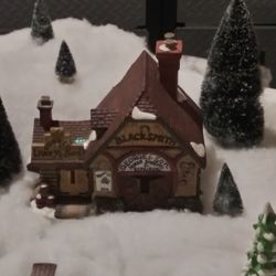 Lighted porcelain Livery, Feed and Blacksmith Building.  From the Heartland Valley Village collection.