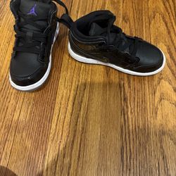 Black Jordan’s with blue Nike Logo