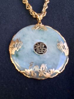Gold and jade pendant with a 30" gold plated Sterling Silver rope chain. $500