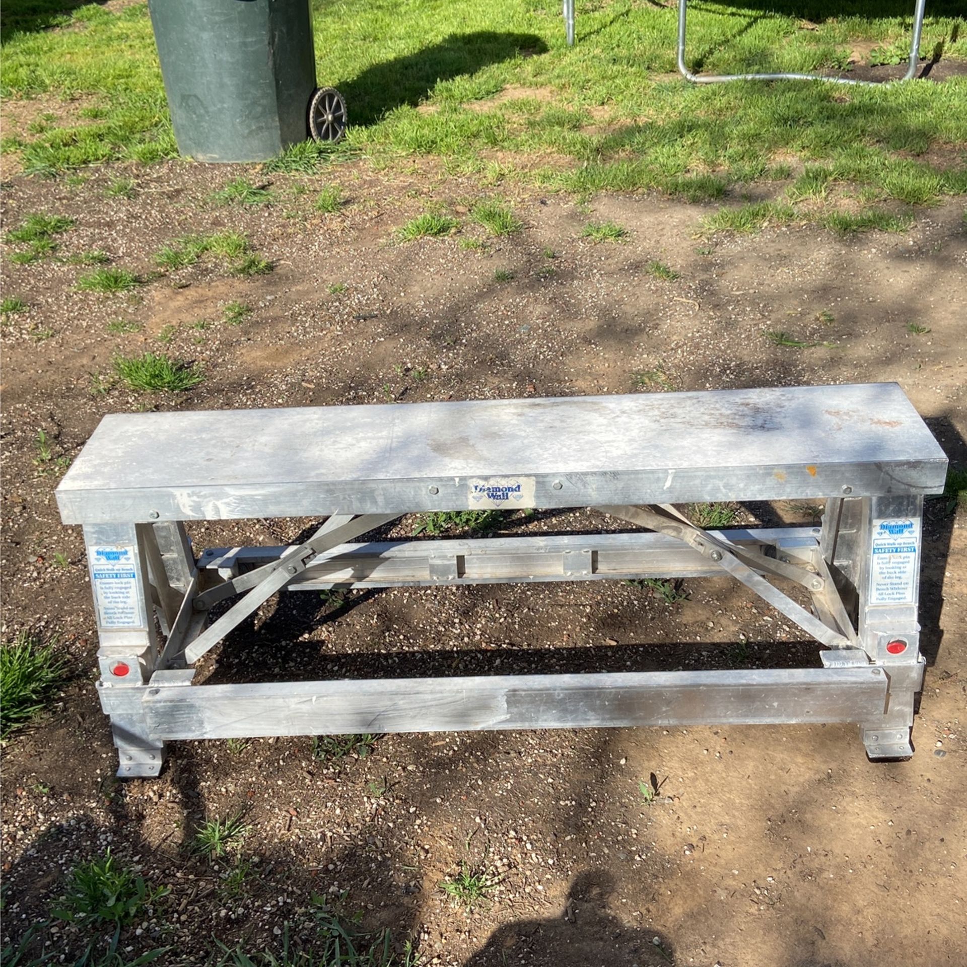 Adjustable postal height drywall bench