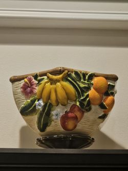 collection consists of Tuscan and Traditional Country Market Fruit-Themed Ceramic Kitchenware. These decorative and functional storage pieces feature 