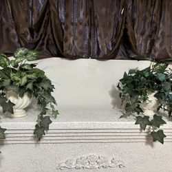 Pair of artificial vine plants in faux stone planters