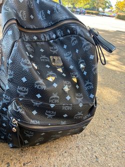 MCM Stark Backpack in black Visetos coated canvas, accented by signature metal pyramid studs a
