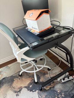 Glass drafting desk and ergonomic chair