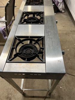 commercial-style 3-burner propane cooktop/range setup, likely intended for outdoor cookin