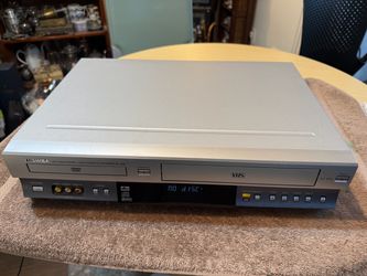 Reliable Toshiba SD-V290 DVD/VCR combo unit is silver. This device has a front-loading DVD tray and a VHS cassette slot. It includes front-facing RCA