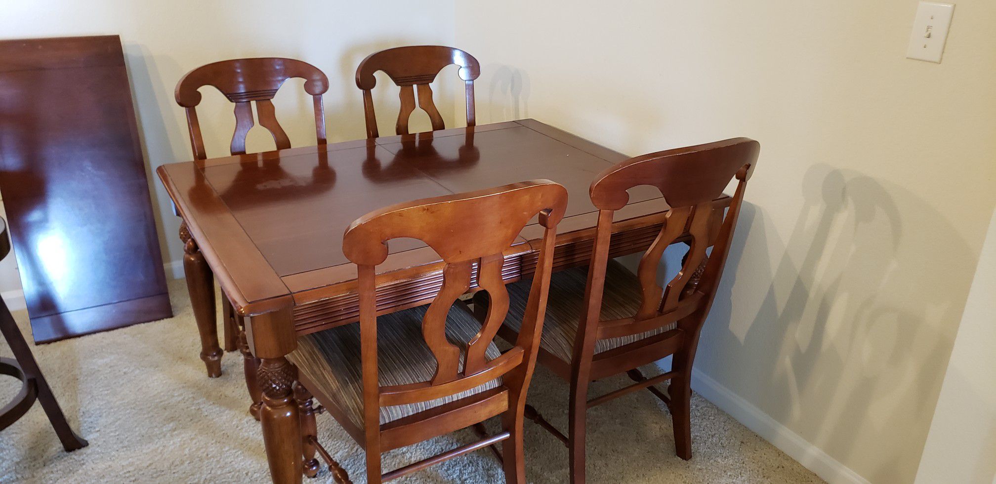 Hard wood dining table with four chairs and extension.
