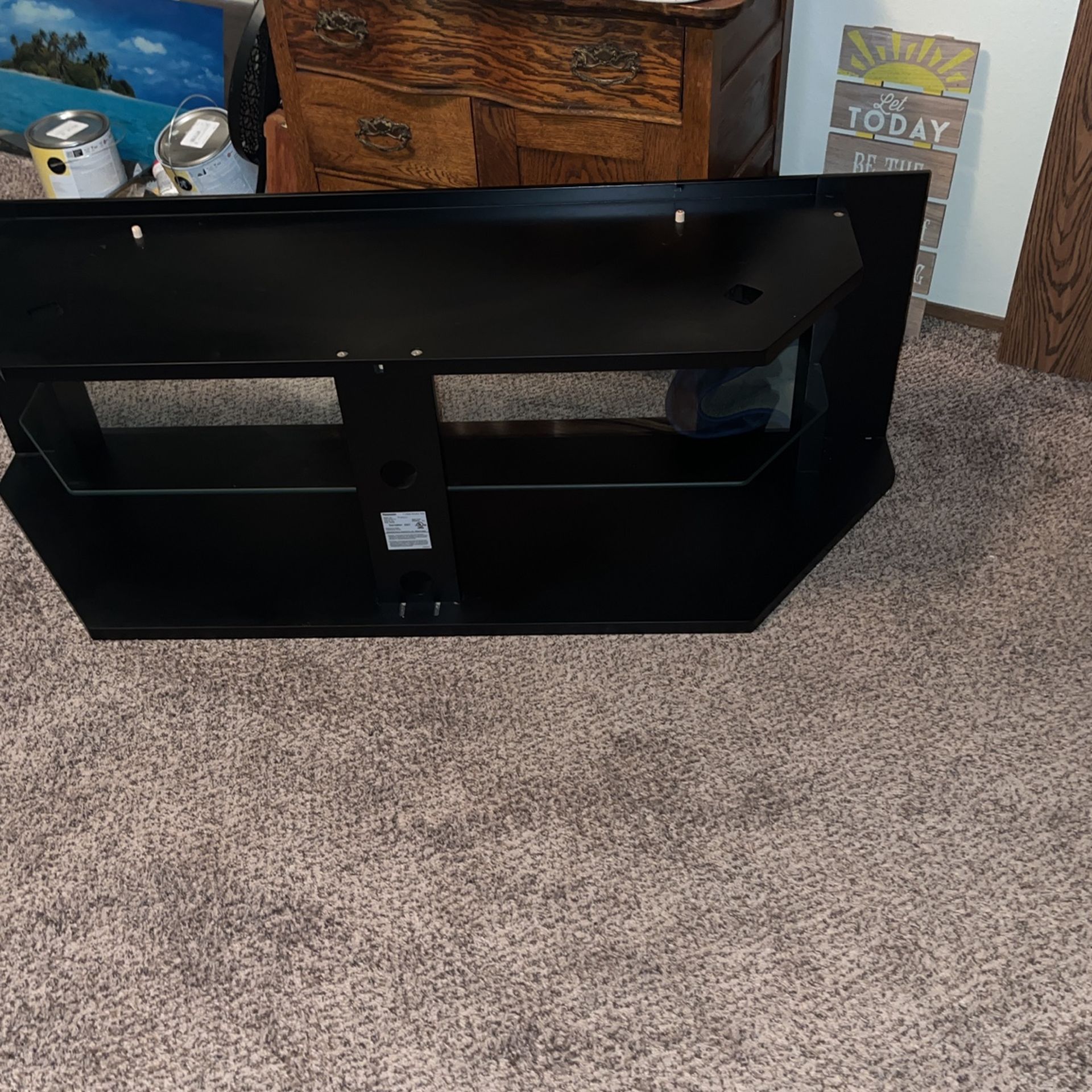 Black TV stand with glass shelves