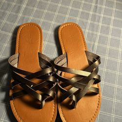 Stylish black leather sandals with crisscross straps.