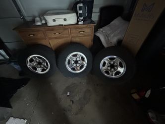 3 rims for sale with their tires and caps