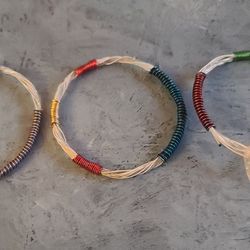 Bracelets made with guitar strings.