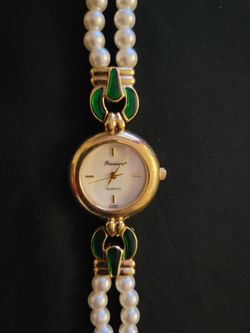 Vintage gold-tone women's bracelet watch needs batteries featuring green enamel accents and a double strand of pearls.